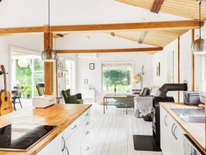 a kitchen and living room with white walls and wooden beams at 6 person holiday home in Nykøbing Sj-By Traum in Nykøbing Sjælland