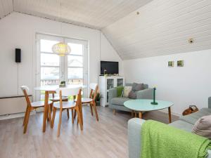 a living room with a couch and a table at 5 person holiday home in Rømø-By Traum in Sønderby
