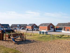 a playground in front of a row of houses at 5 person holiday home in Rømø-By Traum in Sønderby