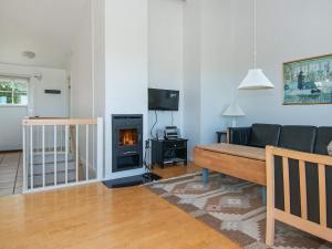 a living room with a couch and a fireplace at 6 person holiday home in Aabenraa-By Traum in Aabenraa
