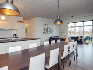 a kitchen and dining room with a table and chairs at 14 person holiday home in Glesborg in Glesborg
