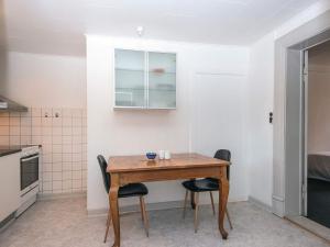 a small kitchen with a wooden table and chairs at Charming Retreat by Fjord - By Traum Ferienwohnungen in Ringkøbing +29 photos