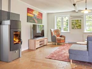 a living room with a fireplace and a couch at 14 person holiday home in Rønne-By Traum in Rønne