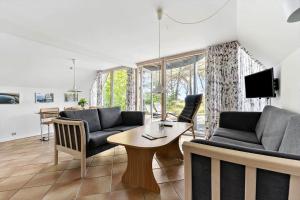 a living room with two couches and a table at 3646-Nexo-Frederiksvej-8 in Neksø