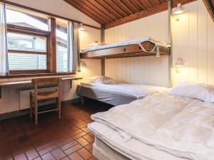 a bedroom with two beds and a desk and a window at Holiday home in a park in Gilleleje in Gilleleje +59 photos