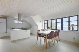 a kitchen and dining room with a table and chairs at 6797-Allinge-Nordre-Strandvej-127 in Allinge