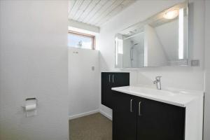 a bathroom with a sink and a mirror at 6797-Allinge-Nordre-Strandvej-127 in Allinge +14 photos