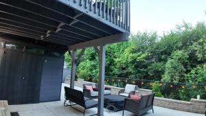 a patio with a table and chairs and a balcony at 2 Bedroom Walkout Basement Ajax in Ajax