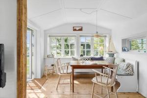a dining room with a table and chairs at 6667-Allinge-Solvej-1-B in Allinge
