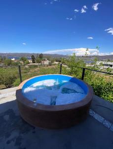 a jacuzzi tub on a balcony with a view at EL PALMAR in Villa Carlos Paz