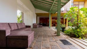 a couch sitting in the middle of a patio at Waves Hostel in Negombo