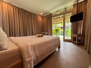 a bedroom with a bed with a stuffed animal on it at Villa Alisha in Canggu +53 photos