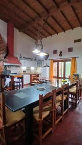 a large kitchen with a large table and chairs at Apart Don Ángel Tandil in Tandil