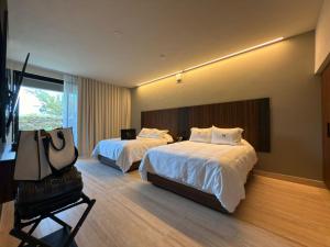 Postel nebo postele na pokoji v ubytování Hotel Montessuites