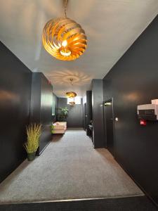a hallway with black walls and a chandelier at New City Centre Flat No 1 2 Bedrooms Free Parking in Leicester