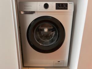 a washing machine is sitting in a room at Soar Luxury Studio en el centro de Salta in Salta