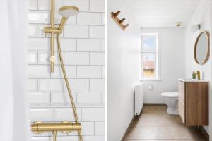 a bathroom with white walls and a gold shower at 5619-Svaneke-Hans-Thygesensvej-1 in Svaneke