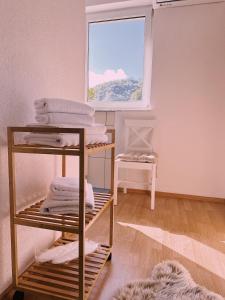 a room with a stack of towels and a window at Layal Home in Bihać