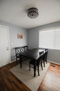 a dining room with a black table and chairs at Bright and Peaceful Apt in Midvale in Midvale