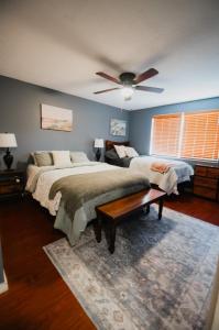 a bedroom with two beds and a ceiling fan at Bright and Peaceful Apt in Midvale in Midvale