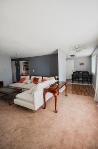 a living room with a white couch and a table at Bright and Peaceful Apt in Midvale in Midvale