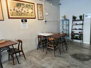 a restaurant with tables and chairs in a room at Sunshine House in George Town