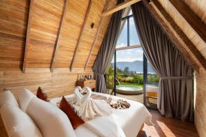 a bedroom with a bed with a large window at Kintamani Breeze in Kubupenlokan +64 photos