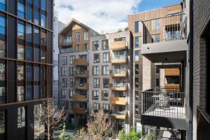 an apartment building with a balcony in a city at Urban Rest Dublin Docklands in Dublin