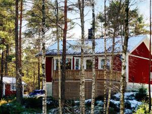 a house with a red barn in the woods at 5 person holiday home in Bullaren-By Traum in Bullaren +16 photos