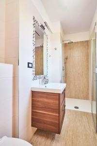 a bathroom with a sink and a shower at Villas Montrin in Kaštel