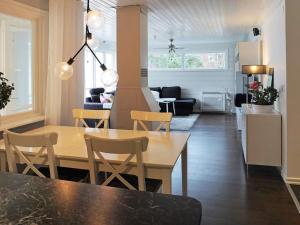 a dining room and living room with a table and chairs at 5 person holiday home in Nösund in Nösund