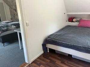 a small bedroom with a bed and a desk at 5 person holiday home in LÖDDEKÖPINGE in Löddeköpinge