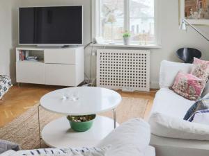 a living room with a white table and a tv at 5 person holiday home in BÅSTAD in Båstad