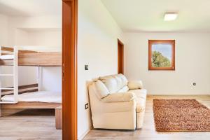 a living room with a couch and a bunk bed at Villas Montrin in Kaštel +45 photos