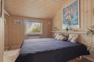 a bedroom with a bed in a room with a window at 2608-Nexo-Munkegardsskoven-17 in Neksø