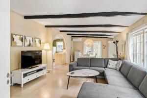 a living room with a couch and a tv at 3501-Nexo-Granvej-6 in Neksø