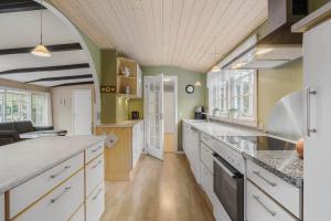 a large kitchen with white cabinets and a large island at 3501-Nexo-Granvej-6 in Neksø