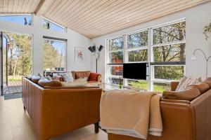 a living room with couches and a flat screen tv at 3712-Nexo-Aastien-8 in Neksø