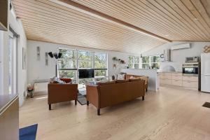 a living room with two couches and a kitchen at 3712-Nexo-Aastien-8 in Neksø