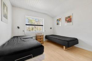 a bedroom with two beds and a window at 3712-Nexo-Aastien-8 in Neksø