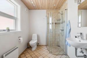 a bathroom with a shower and a toilet and a sink at 3712-Nexo-Aastien-8 in Neksø +13 photos