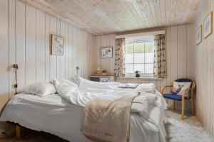 a bedroom with a large bed with white sheets at HA286-Saeby-Nellemannsvej-12 in Sæby