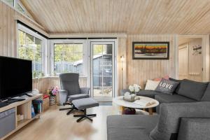a living room with a couch and a tv at HA286-Saeby-Nellemannsvej-12 in Sæby
