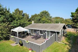a small house with a deck and a gazebo at HA286-Saeby-Nellemannsvej-12 in Sæby