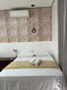 a bedroom with a bed with two towels on it at CASA CONFORTÁVEL COM 4 QUARTOS EM ALTER DO CHÃO in Alter do Chao +41 photos