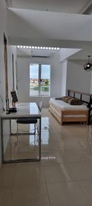 a bedroom with two beds and a table with a laptop at Jonah by The Sea Hideaway Cabin in Ban Sam Maitri