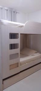 a white bunk bed with its door open at Apartamento Playa Familiar Ciudad Flamingo Tucacas Chichiriviche in Tucacas