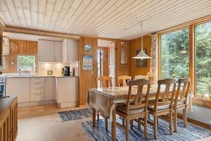 a kitchen and dining room with a table and chairs at HA374-Saeby-Klitvej-12 in Sæby