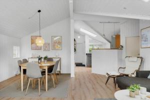 a dining room and living room with a table and chairs at OH551-Hadsund-Ved-Fruerlund-35 in Hadsund