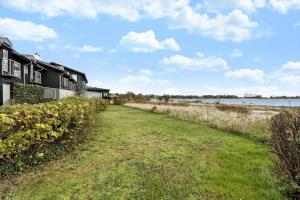 a house on the shore of a body of water at FY342-Martofte-Fynshovedvej-854-H in Martofte +13 photos